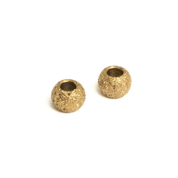 Homokf�vott hat�s� gy�ngy 3x2 mm arany nemesac�l 2 db